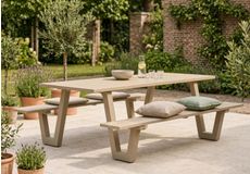 Moderne houten picknicktafel met twee banken en grijze zitkussens op een groene tuin